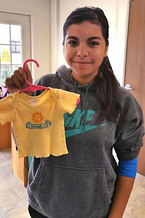 Participant Holds Shirt She was Given as an Infant in Maternity Ward